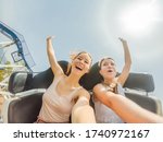 Two happy girls having fun on rollercoaster