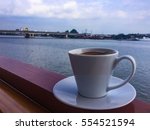 A cup of coffee on the boat near the river