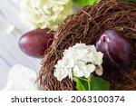 ripe plums in a vine basket on... | Shutterstock . vector #2063100374