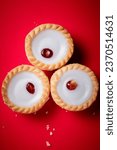 Small photo of commecial photos of Viennese Whirls and Bakewell tarts on metal tray and with coloured backgrounds