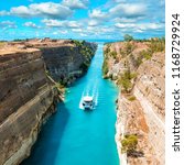 Small photo of Beautiful scenery of the Corinth Canal in a bright sunny day against a blue sky with white clouds. Among the rocks floating white ship in turquoise water.
