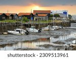 Small photo of View of the town (commune) of Gujan-Mestras at low tide of the Atlantic in the morning Ocean water receded from the Arcachon Bay at low tide. Gironde department, region Nouvelle-Aquitaine