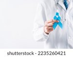 Small photo of doctor in a white coat hands holding Blue ribbon for supporting people living and illness, Colon cancer, Colorectal cancer, Child Abuse awareness, world diabetes day, International Men's Day