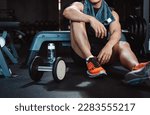 Small photo of Man exercise workout in gym fitness breaking and resting after training sport with dumbbells and water bottle healthy lifestyle bodybuilding.