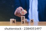 Small photo of Task priority and management concept, The order of priority in any activity, Set work priority, arrange to do list. Hand arranging Wooden cube blocks with number first, second, third, four, five.
