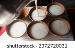 Small photo of Lassi in culled ( clay pots ) getting filled group shot