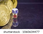 Small photo of Conceptual image of dicey, risky and speculative investment in crypto currency. Dice and coins on reflective dark surface and background. Focus on dice.