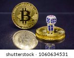 Small photo of Conceptual image of dicey, risky and speculative investment in crypto currency. Dice and coins on reflective dark surface and background. Focus on dice.