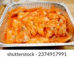 Small photo of Saucy Raw Hot Wings in a Foil Pan