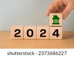 Small photo of 2024, housing market analysis, construction cost, apartment prices, apartment rent, mortgage rate, Business and financial concept, typography, Wooden blocks with date and house icon, copy space
