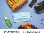 Winter tourism during coronavirus COVID-19 restriction. Travel accessories and disposable face mask, hydroalcoholic sanitizer gel