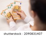 Small photo of Close up of Person Hands Counting Money, Salary, Income, Savings, Money, Euros. Woman count euro 50 banknotes. Family budget. Count euros, Money counting