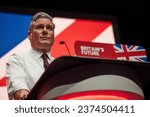 Small photo of Liverpool, United Kingdom - October 10 2023: Labour Party Conference. Leader of the Opposition, Sir Keir Starmer speaking to conference, sleeves rolled up and covered in glitter from a recent protest