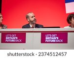 Small photo of Liverpool, United Kingdom - October 9 2023: Labour Party Conference. Shadow Business Secretary, Jonathan Reynolds listening to Shadow Chancellor of the Exchequer, Rachel Reeves' speech.