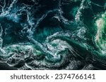 Small photo of Abstract background. Waves of water of the river and the sea meet each other during high tide and low tide. Whirlpools of the maelstrom of Saltstraumen, Nordland, Norway