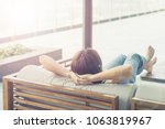 Small photo of Good life of easy relax Asia woman do nothing or daydreaming with hand stretching up sitting at home or hotel near swimming home. Happy people lifestyle concept.