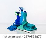 still life with cleaning supplies with different shades of blue, on white background