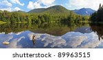 Panoramic view of Phelps Mt, Mt Marcy and Mt. Colden reflected in Marcy Dam Pond in the High Peaks region of the Adirondack Mountains of New York