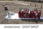 Small photo of Ulubelu, Indonesia - February 2nd 2021: Fire extinguisher tubes are arranged on white tarpaulin and will be used to simulate how to use fire extinguisher to extinguish fire in the field during the day