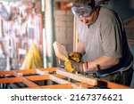 Design people person factory repair shop concept. Portrait of serious brutal master using mallet and chisel