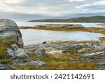 Small photo of Rocky shores of the Porsanger Fjord, Barents Sea, on a calm late summer evening, Finnmark, Norway