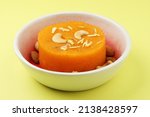 Small photo of Rava Kesari , Saffron flavoured Semolina Soji Halwa also known as Sweet Rava Sheera or Shira - Indian festival sweet garnished with dry fruits, selective focus