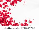 Valentine's Day. Flowers composition. Round frame made of rose flowers, confetti on white background. Valentines day background. Flat lay, top view, copy space.