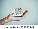 Toy Ship In Hands