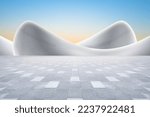 Modern art curved building with empty brick square against clear sky background.