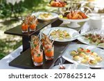 Small photo of Delicacy snacks, wedding or party catering outdoors. Appetizer bar with shrimps, cheese and caviar. Professional restaurant serving in banquet, luxury event.