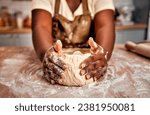 Small photo of Details in baking process. Close up of black female hands molding raw dough on wooden table powdered with flour. Experienced housewife working accurate with bread base to fill with air for softness.
