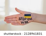 children's palm with the inscription stop war and the flag of ukraine, the actual concept of anti-war support.