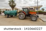 Small photo of Torrevieja, Alicante, Spain - May 29 2019 : Masey Ferguson tractor towing water tank parked on roadside in Spain