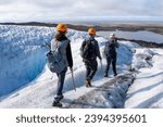 Small photo of Hikers on Falljokull glacier in Iceland wearing harnesses, ice axes, crampons and helmets