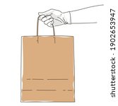 hand in glove holding paper bag.... | Shutterstock .eps vector #1902653947