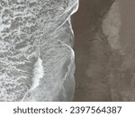 Small photo of a sea like silk waves strewed across smooth sands