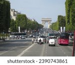 Small photo of Paris, France September 7 2010: driving in traffic on Champs Elysees with the Arc de Triomphe in view in Paris France with unidentified people cars and buses