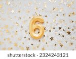 Number 6 six golden celebration birthday candle on on Festive Background. Six years birthday. concept of celebrating birthday, anniversary, important date, holiday