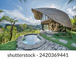 Small photo of Eco-friendly Bamboo House with Natural Pool and Greenery: A picturesque view of a modern, eco-friendly bamboo house with a thatched roof, nestled amidst lush greenery.