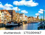 Old historic district Delfshaven with wildmill and houseboats in Rotterdam, South Holland, The Netherlands. Summer sunny day