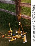 Small photo of A set of croquet mallets and coloured balls.