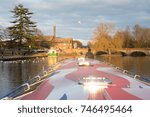Small photo of UK autumn fall view of weather deck on canal barge with sun shining on hatches