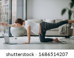 Pregnant woman exercing yoga at home