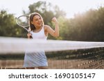 Young Woman Playing Tennis At...
