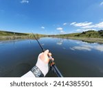 Small photo of Holding a fishing rod assasin tempest on a dam in south africa