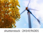 Small photo of Windmill electric power source and the yellow flower of Golden Shower or Cassia Fistula, Clean energy concept from the wind in nature, environmentally friendly to reduce global warming for background