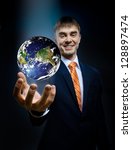 Small photo of businessman hold in hand terrestrial globe, blue background, business concept image planet by: Stokli, Nelson, Hasler Laboratory for Atmospheres Goddard Space Flight Center www.rsd.gsfc.nasa.gov/rsd
