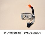 Scuba diving mask with a snorkel on the white sea sand. Diving mask. Photo of a mask and snorkel for swimming in the pool or sea with a central composition on the beach. Scuba diving concept