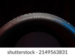 Small photo of 09 of April 2022 - Vinnitsa, Ukraine. New car tire Michelin Primacy 4 plus. Road wheel on dark background. Summer Tire with asymmetric tread design. Driving car concept.
