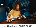 Young curly woman playing cyber games. High quality photo